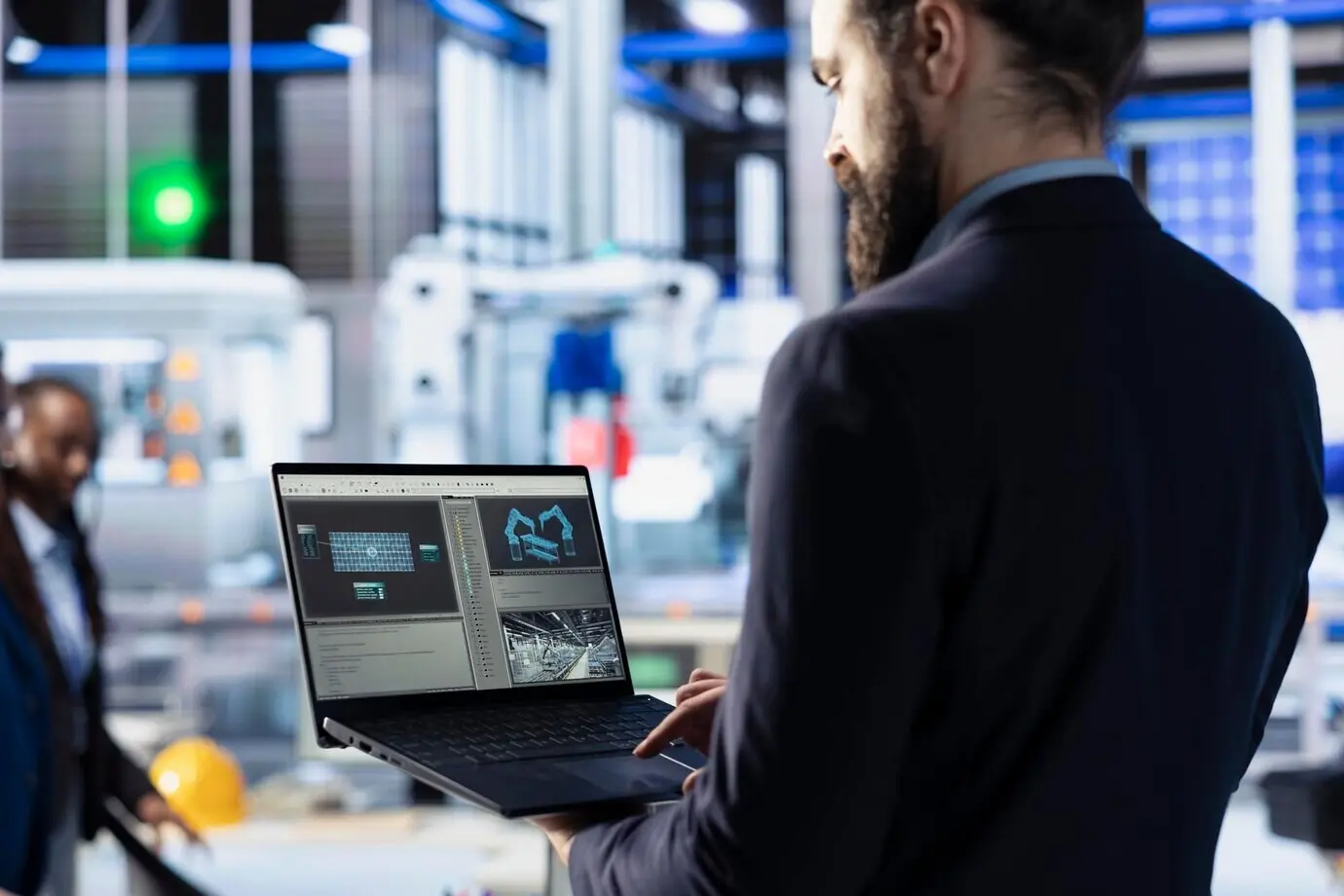 A photovoltaics factory technician uses a laptop to optimize the production flow.
