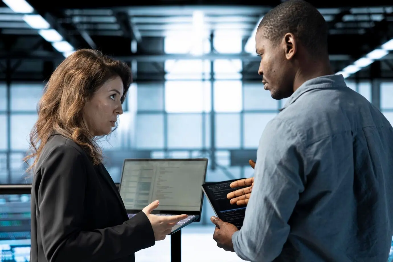 Engineers in a data center using devices that utilize machine learning models.