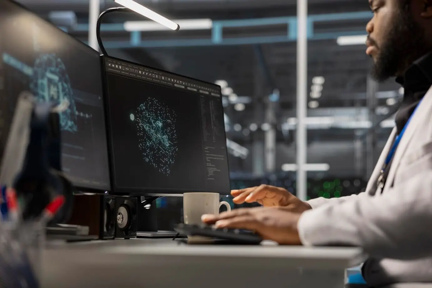 An engineer working on a PC in a data center that houses artificial intelligence equipment.